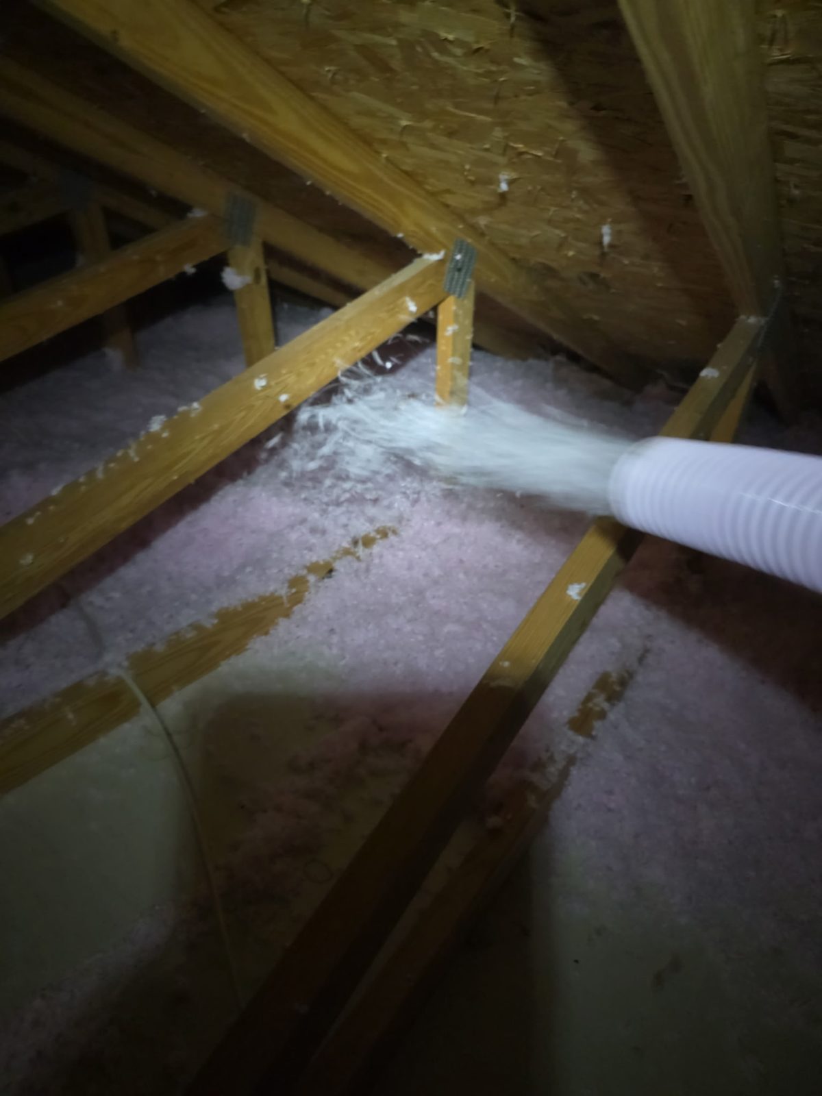 Blowing fresh insulation into an Indianapolis attic